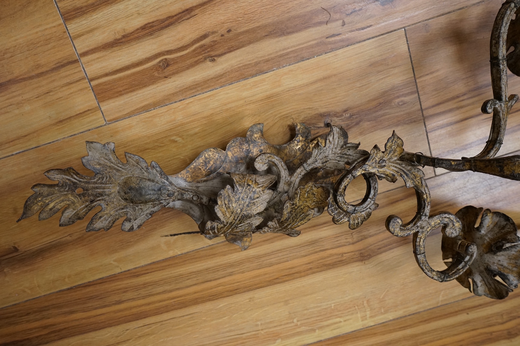 Four French decorative metal two branch wall sconces, 63cm high including faux candle attachments, including silk shades